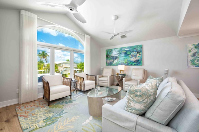 living room with vaulted ceiling, ceiling fan, and light hardwood / wood-style flooring