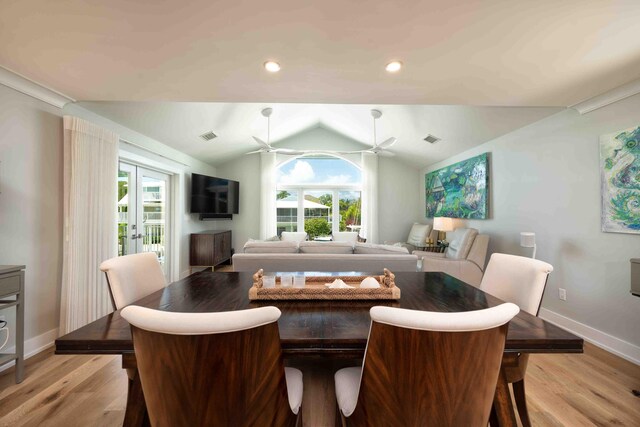 dining space featuring french doors, ceiling fan, vaulted ceiling, and light hardwood / wood-style flooring