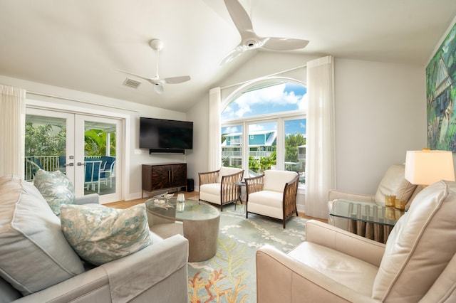 living room with light hardwood / wood-style flooring, vaulted ceiling, french doors, and ceiling fan