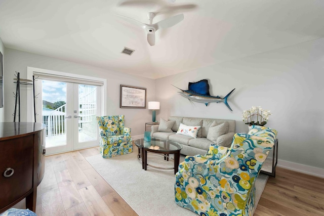 living room featuring ceiling fan, light wood-type flooring, and french doors