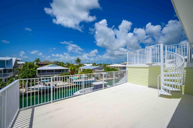 view of patio / terrace featuring a water view and a boat dock