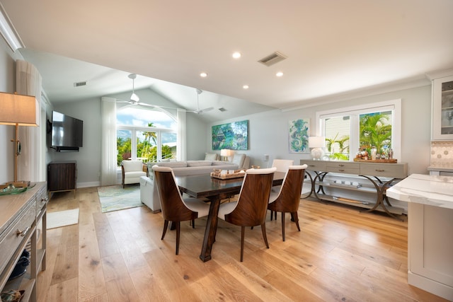 dining room featuring vaulted ceiling, ceiling fan, and light hardwood / wood-style floors