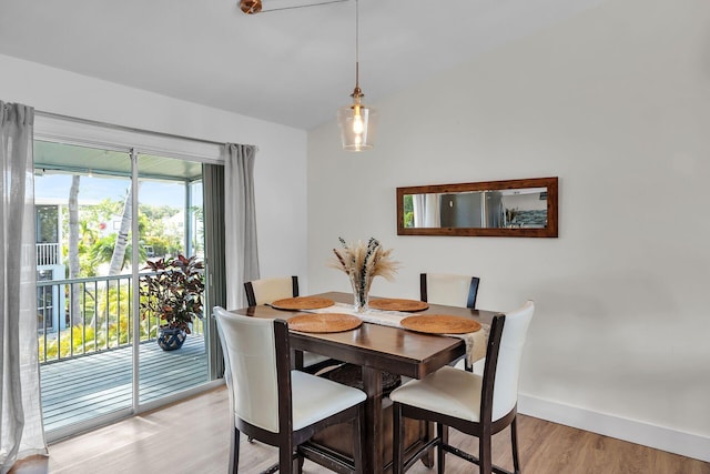 878 La Paloma Rd, Key Largo, FL 33037 - dining area with light wood-style flooring, baseboards, and vaulted ceiling