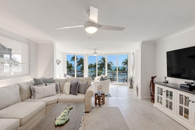 tiled living room with ornamental molding and ceiling fan