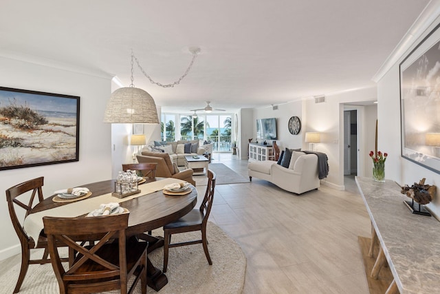 dining room with crown molding and ceiling fan