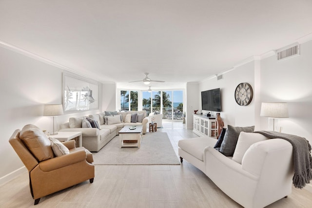 living room featuring ceiling fan and ornamental molding