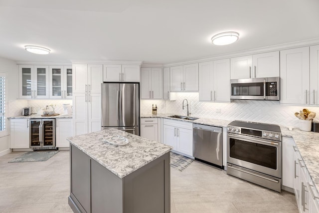 kitchen featuring white cabinets, appliances with stainless steel finishes, and beverage cooler