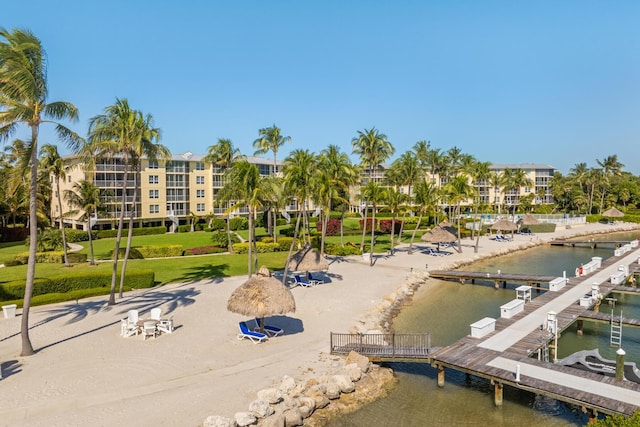 view of home's community featuring a water view and a boat dock