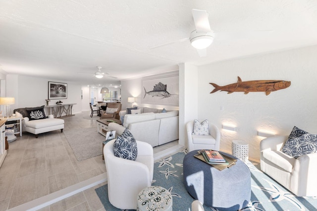 living room with ceiling fan and a textured ceiling