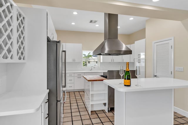 28573 Le Grand Rd, Little Torch, FL 33042 - kitchen featuring freestanding refrigerator, a kitchen island, island range hood, open shelves, and light tile patterned floors