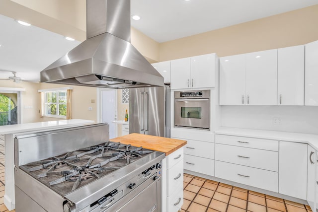 28573 Le Grand Rd, Little Torch, FL 33042 - kitchen with island range hood, appliances with stainless steel finishes, white cabinets, light tile patterned flooring, and recessed lighting