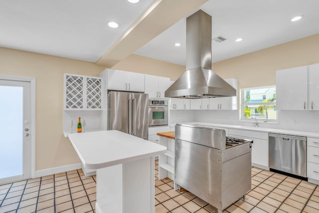28573 Le Grand Rd, Little Torch, FL 33042 - kitchen with stainless steel appliances, island range hood, light countertops, white cabinets, and recessed lighting