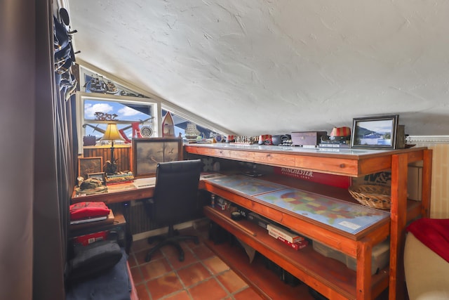 office space with tile patterned flooring and lofted ceiling