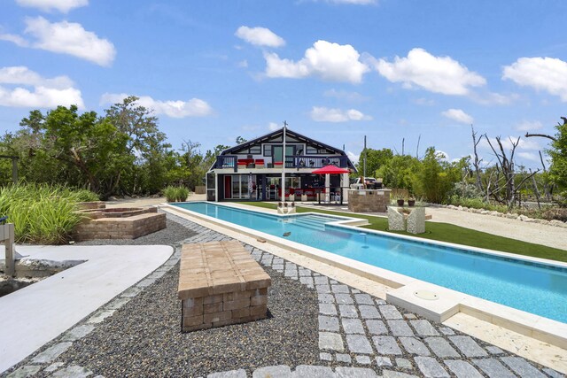 view of swimming pool with a patio area and a hot tub