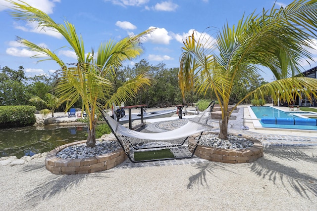 view of community featuring a pool and a patio