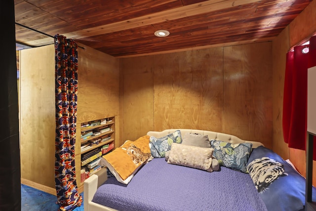 carpeted bedroom with wooden walls and wooden ceiling