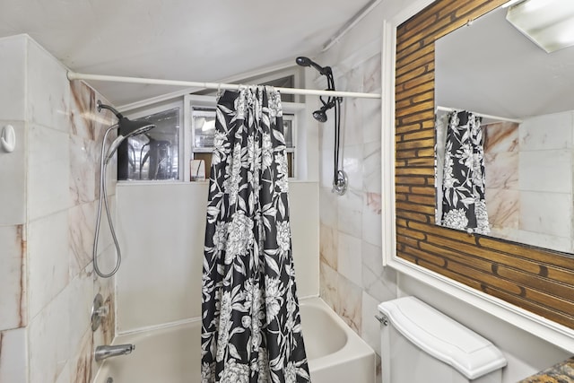 bathroom featuring shower / bath combo and toilet