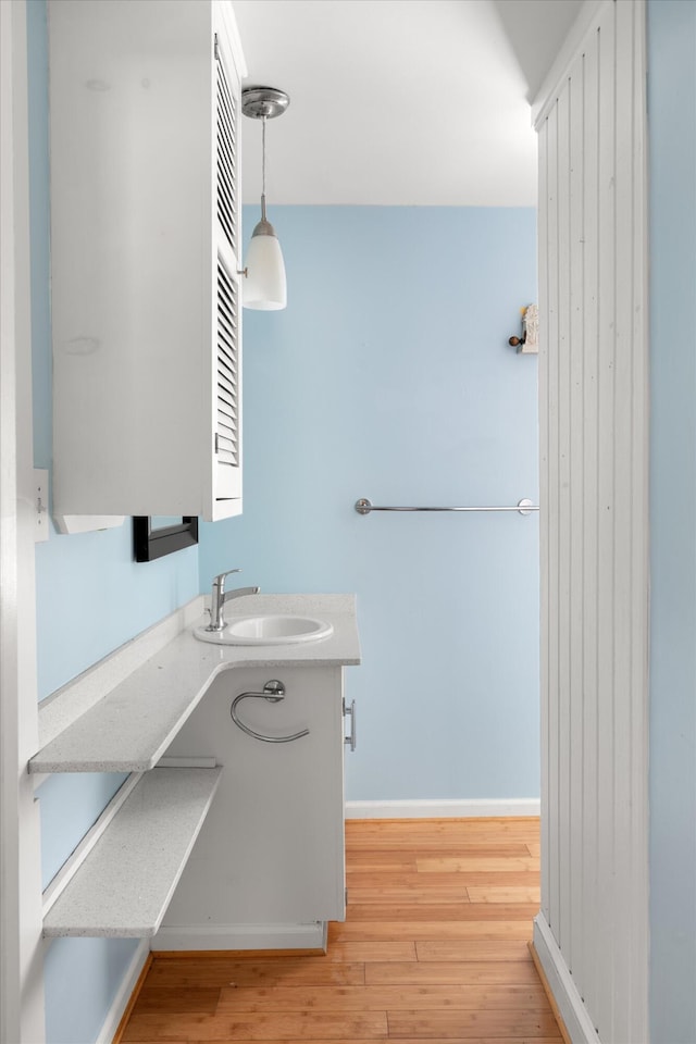 1500 Seminary St Unit 5A, Key West, FL 33040 - bathroom with wood finished floors, vanity, and baseboards