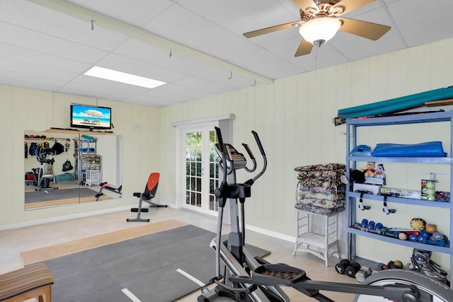 exercise area featuring ceiling fan and tile patterned flooring