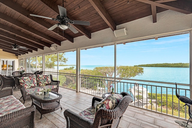 sunroom featuring ceiling fan, a water view, vaulted ceiling with beams, and wood ceiling