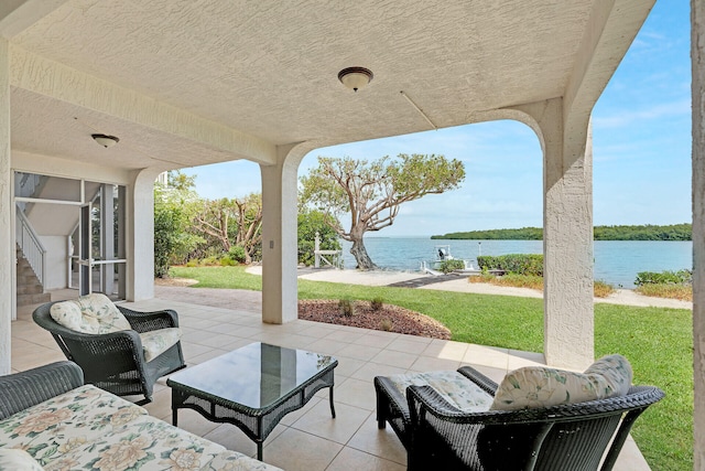 view of patio with a water view