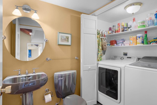 laundry area featuring independent washer and dryer and sink