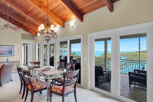 carpeted dining space featuring french doors, a water view, high vaulted ceiling, wooden ceiling, and beamed ceiling