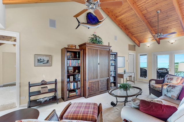 living room with french doors, ceiling fan, light carpet, and beamed ceiling