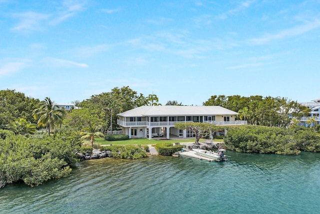 rear view of property with a water view