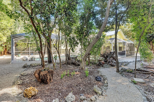 view of yard featuring a patio area and glass enclosure