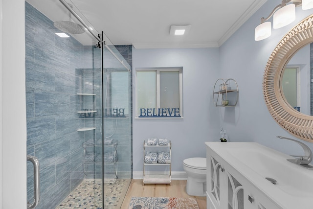 bathroom featuring hardwood / wood-style floors, ornamental molding, vanity, walk in shower, and toilet