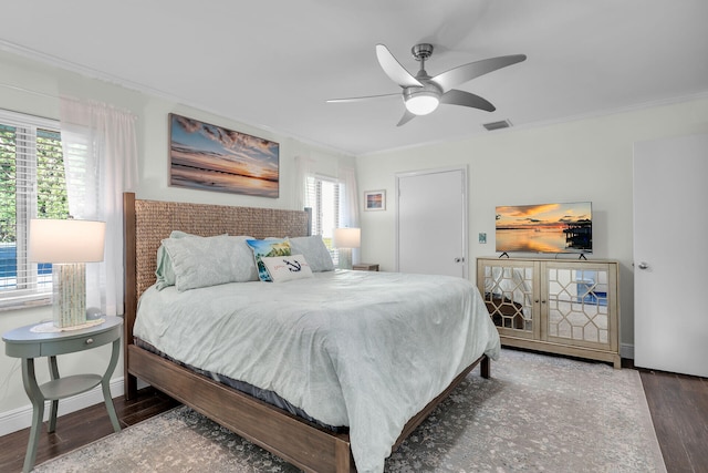 bedroom with crown molding, ceiling fan, and dark hardwood / wood-style floors