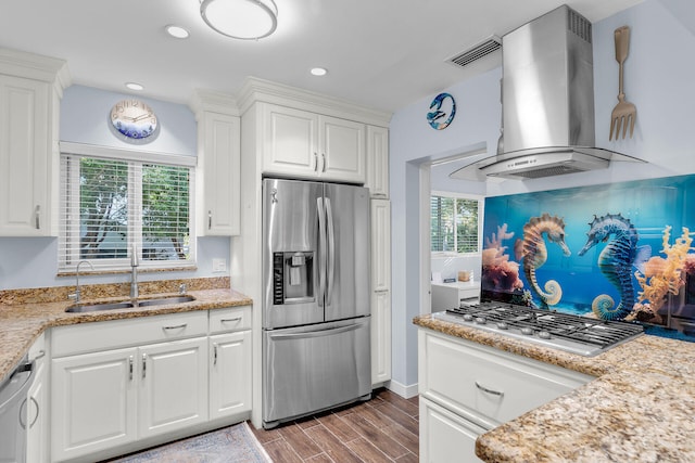 kitchen featuring sink, white cabinetry, light stone counters, stainless steel appliances, and exhaust hood