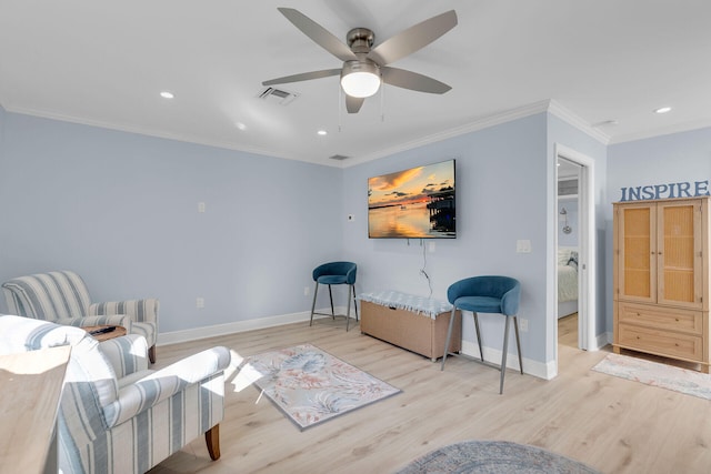 living area featuring crown molding, light hardwood / wood-style flooring, and ceiling fan