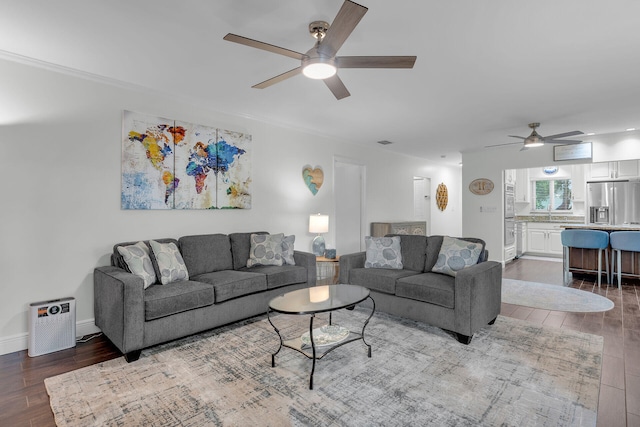 living room with dark hardwood / wood-style floors and ceiling fan