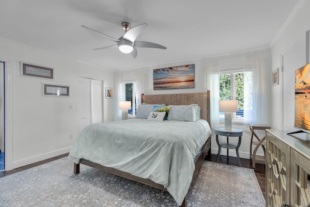 bedroom featuring crown molding, ceiling fan, dark hardwood / wood-style floors, and a closet