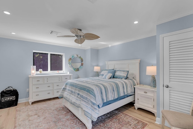 bedroom with light hardwood / wood-style flooring, ornamental molding, and ceiling fan