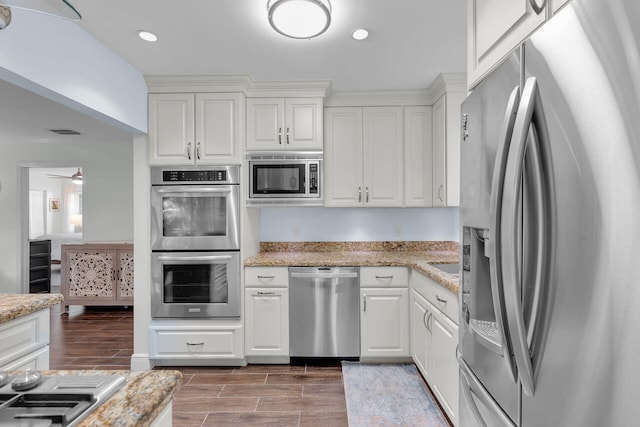 kitchen featuring white cabinetry, light stone countertops, and appliances with stainless steel finishes