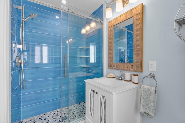 bathroom featuring vanity and a shower with door