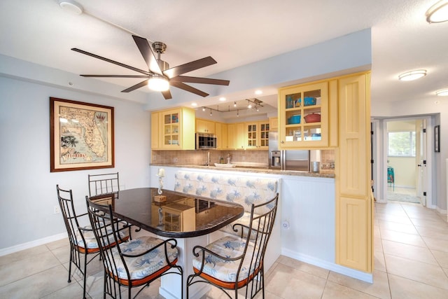 95 Coco Plum Dr Unit 4C, Marathon, FL 33050 - dining space featuring ceiling fan, baseboards, and light tile patterned floors