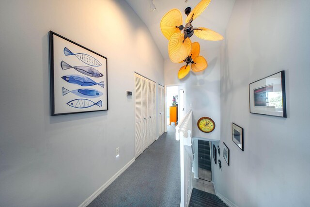 95 Coco Plum Dr Unit 4C, Marathon, FL 33050 - corridor with baseboards, an upstairs landing, carpet, and a towering ceiling