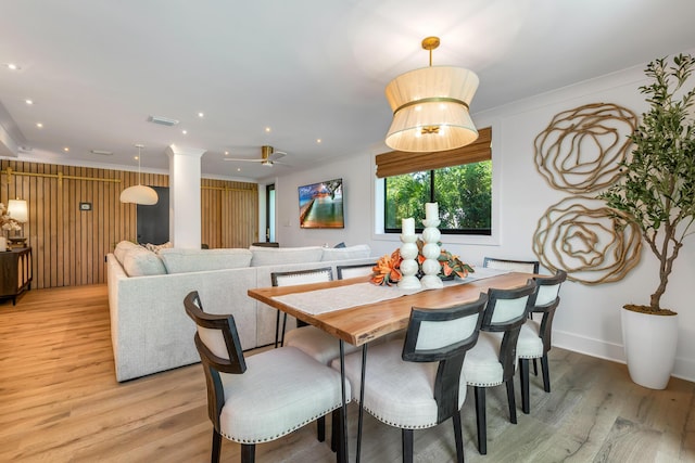 dining area with crown molding, ceiling fan, and light hardwood / wood-style floors