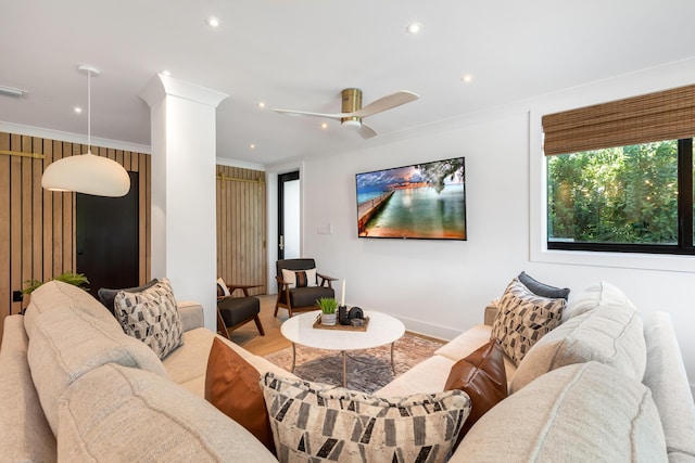 living room featuring crown molding, ceiling fan, and hardwood / wood-style floors