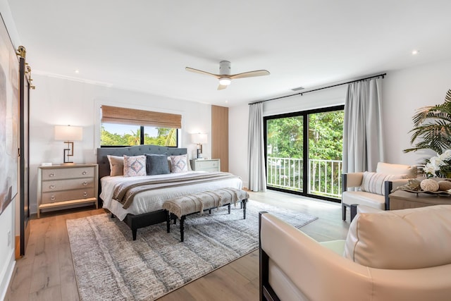 bedroom with access to exterior, light hardwood / wood-style floors, and multiple windows