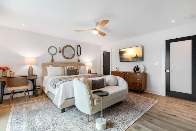 bedroom with ceiling fan and light hardwood / wood-style flooring