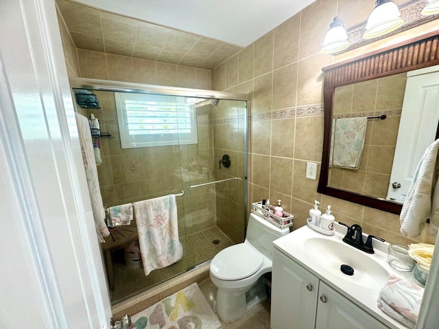 bathroom with walk in shower, toilet, tile walls, vanity, and decorative backsplash