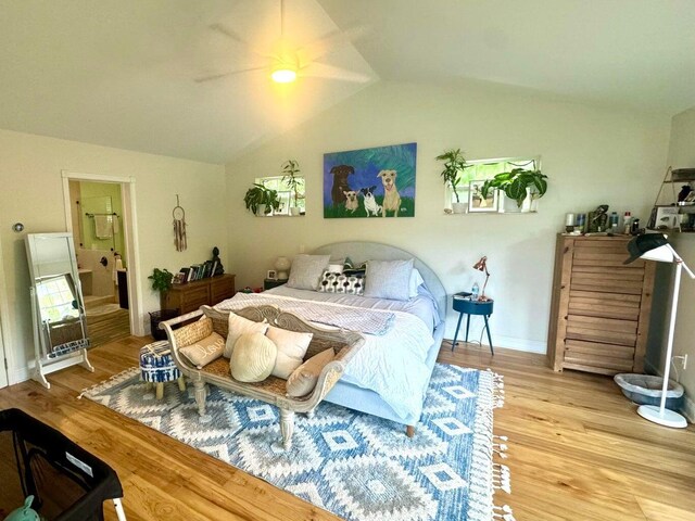 bedroom with ceiling fan, wood-type flooring, and vaulted ceiling