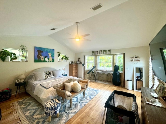 bedroom featuring lofted ceiling, light hardwood / wood-style flooring, and ceiling fan