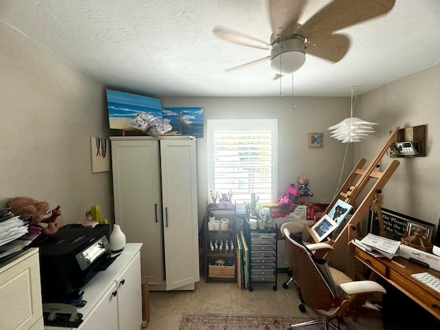 home office with ceiling fan and a textured ceiling