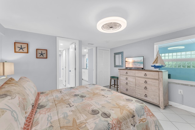bedroom featuring light tile patterned flooring and baseboards